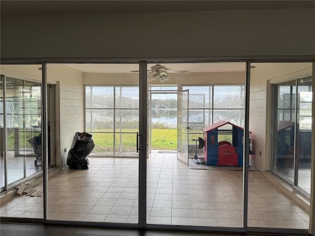 entryway with a water view and ceiling fan