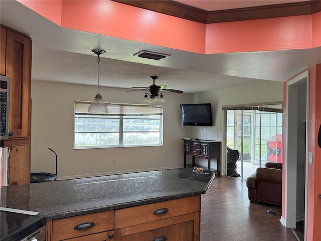 kitchen featuring decorative light fixtures, ceiling fan, and dark hardwood / wood-style floors