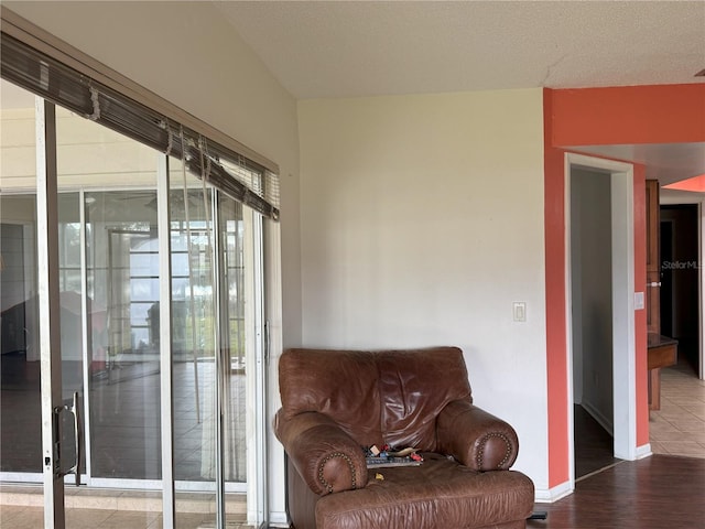 sitting room with hardwood / wood-style flooring and a textured ceiling