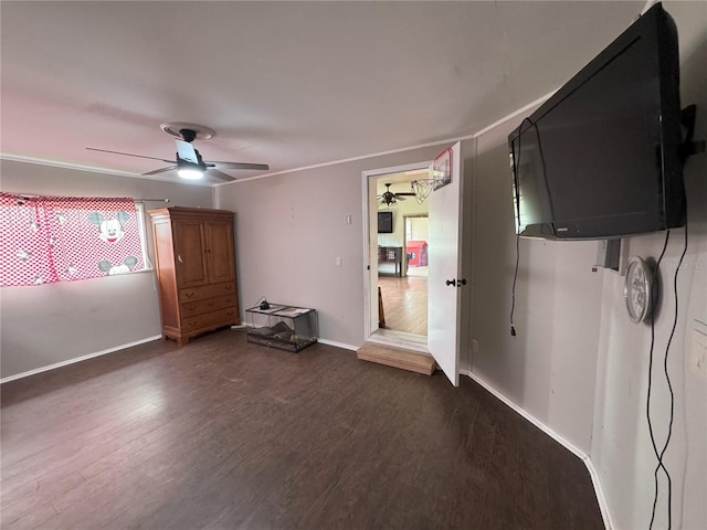 unfurnished bedroom featuring dark wood-type flooring and ceiling fan