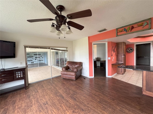 unfurnished room featuring hardwood / wood-style flooring, a textured ceiling, and ceiling fan