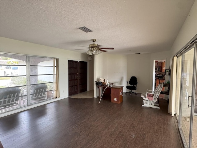 office with ceiling fan, a textured ceiling, and dark hardwood / wood-style flooring