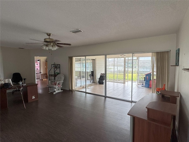 interior space featuring ceiling fan and a textured ceiling