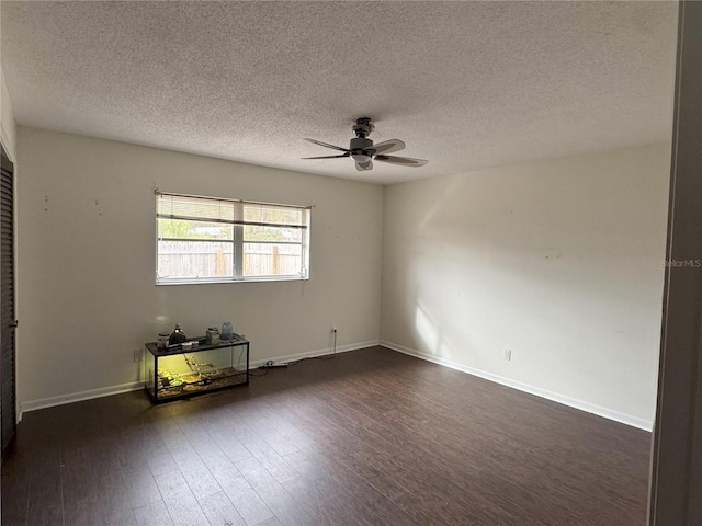 spare room with ceiling fan, a textured ceiling, and dark hardwood / wood-style floors