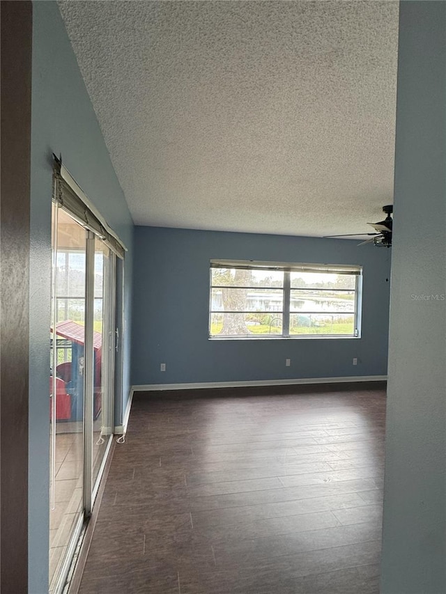 spare room featuring ceiling fan, a textured ceiling, and dark hardwood / wood-style flooring