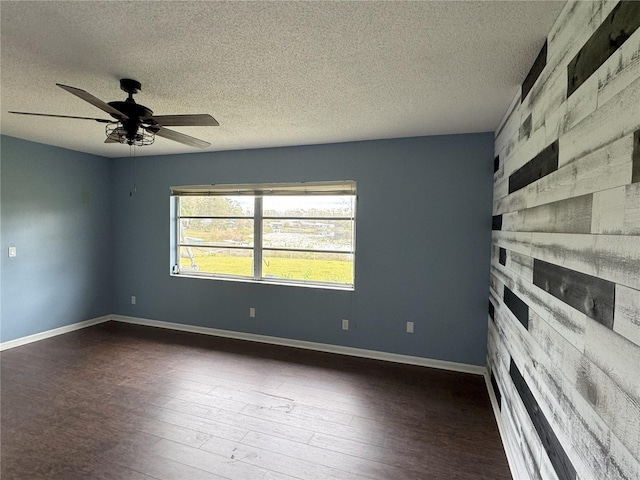 unfurnished room with a textured ceiling, ceiling fan, and dark hardwood / wood-style floors