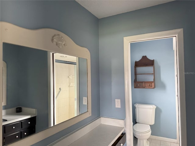 bathroom with toilet and tile patterned flooring