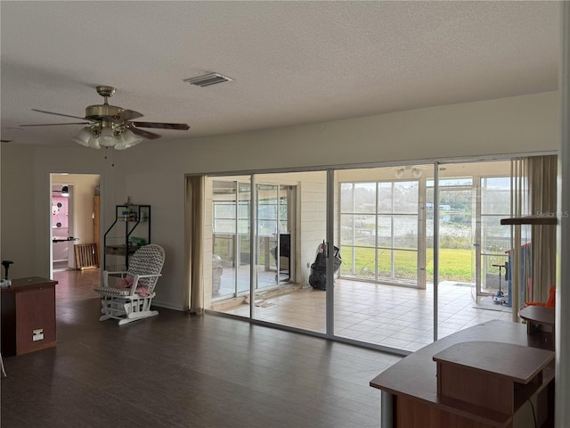 interior space featuring a textured ceiling, ceiling fan, hardwood / wood-style floors, and radiator heating unit