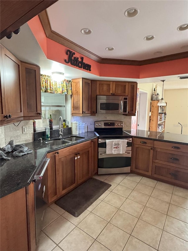 kitchen with decorative light fixtures, sink, stainless steel appliances, ornamental molding, and light tile patterned floors