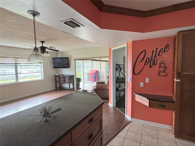 kitchen featuring ceiling fan and light tile patterned floors