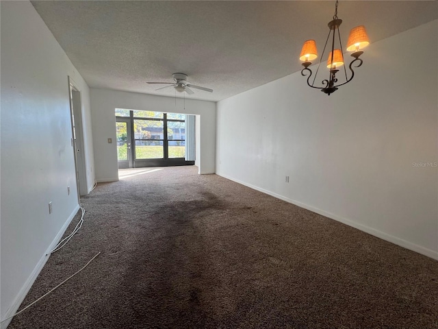 empty room with ceiling fan with notable chandelier, carpet floors, and a textured ceiling