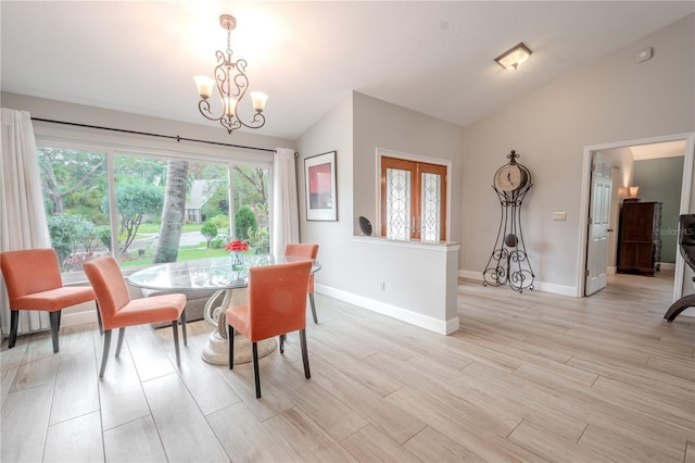 dining space featuring vaulted ceiling, a chandelier, and light wood-type flooring