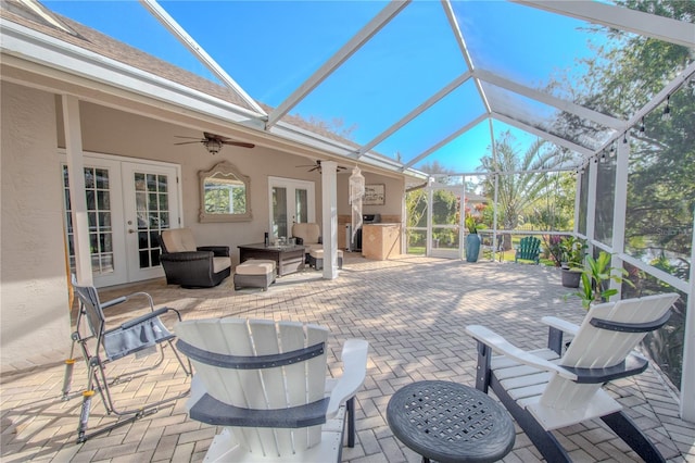 view of patio with french doors, area for grilling, outdoor lounge area, a lanai, and ceiling fan