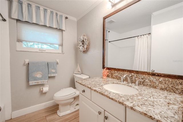 bathroom with ornamental molding, vanity, toilet, a textured ceiling, and a shower with curtain