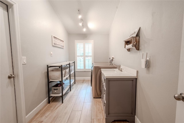 bathroom with vaulted ceiling, a textured ceiling, track lighting, vanity, and hardwood / wood-style flooring