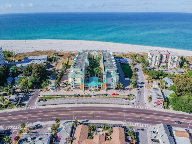 birds eye view of property with a beach view and a water view