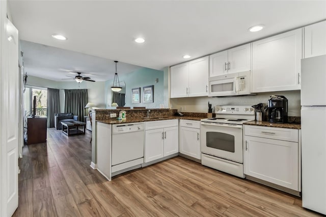 kitchen with white cabinets, pendant lighting, white appliances, and kitchen peninsula