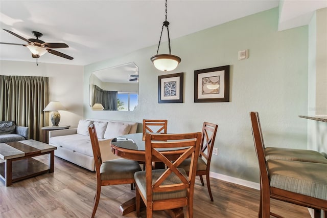 dining area featuring ceiling fan and wood-type flooring