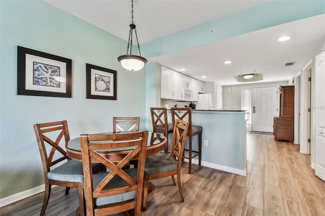 dining area with light hardwood / wood-style floors