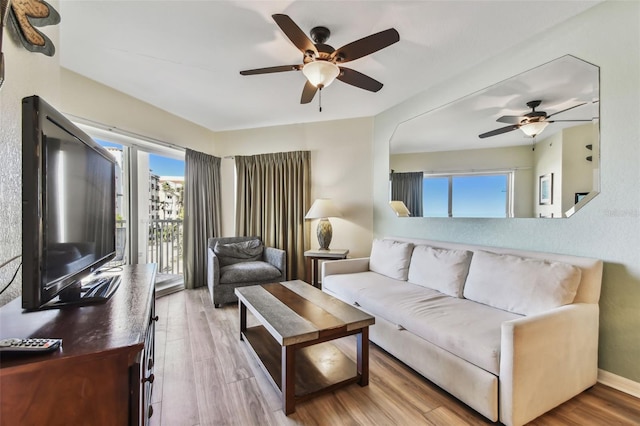 living room featuring hardwood / wood-style flooring and ceiling fan