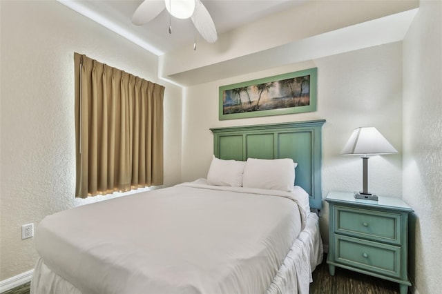 bedroom featuring ceiling fan and dark wood-type flooring