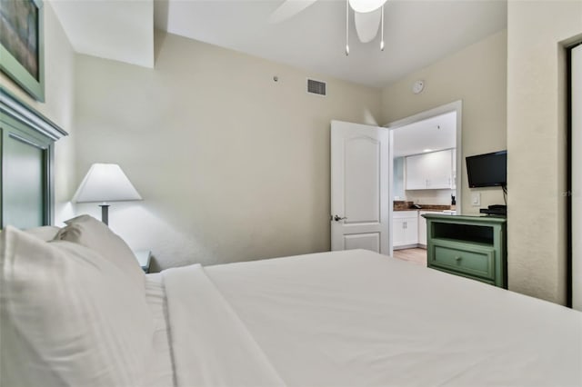 bedroom featuring ceiling fan and ensuite bathroom