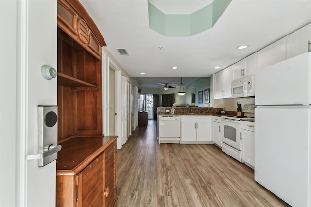 kitchen with white appliances, white cabinets, ceiling fan, light wood-type flooring, and kitchen peninsula