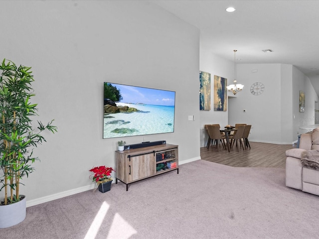 carpeted living room featuring a chandelier