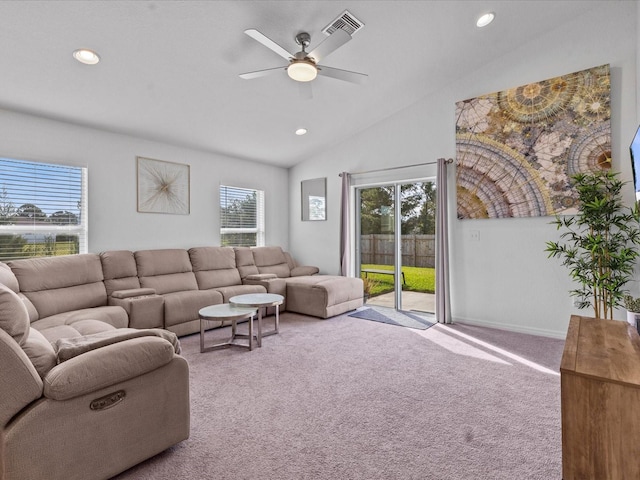 carpeted living room with ceiling fan and lofted ceiling