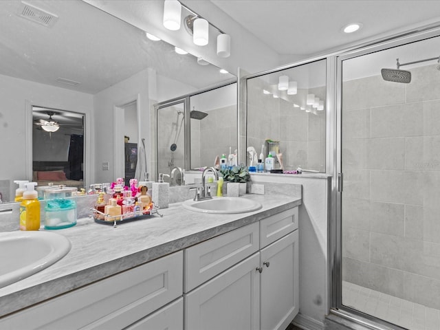 bathroom featuring vanity and an enclosed shower