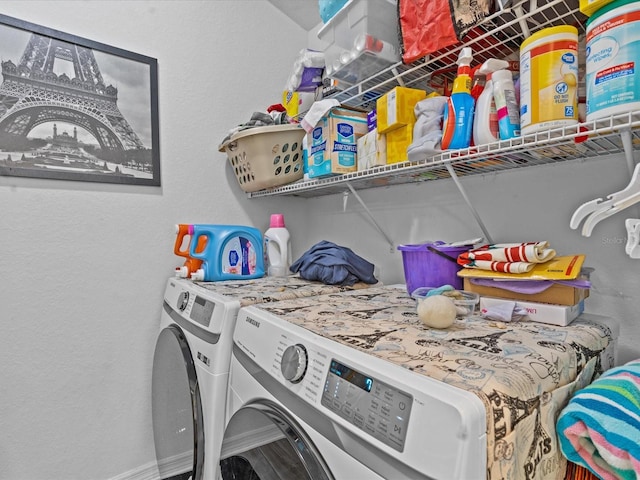 clothes washing area with washing machine and dryer