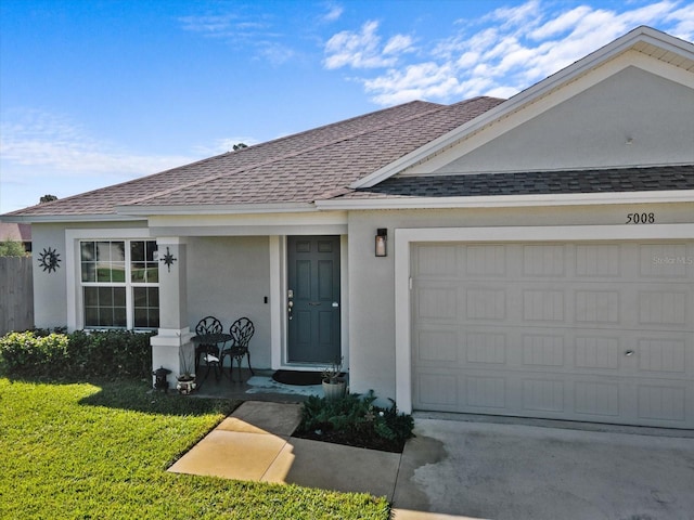 single story home with a front yard and a garage