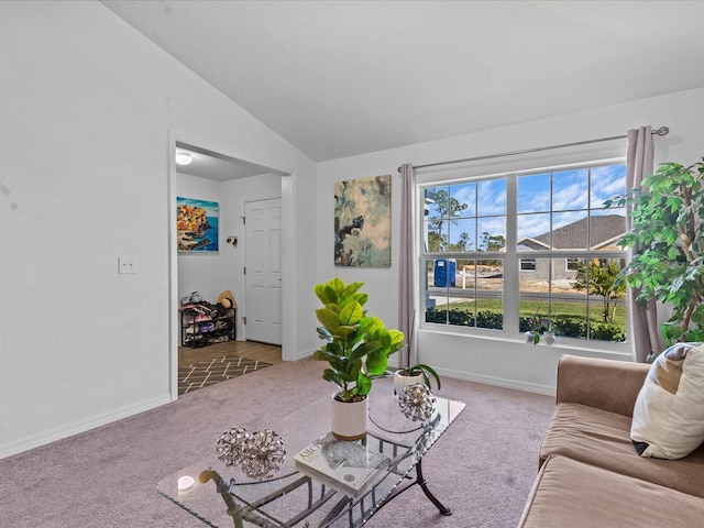 carpeted living room with vaulted ceiling