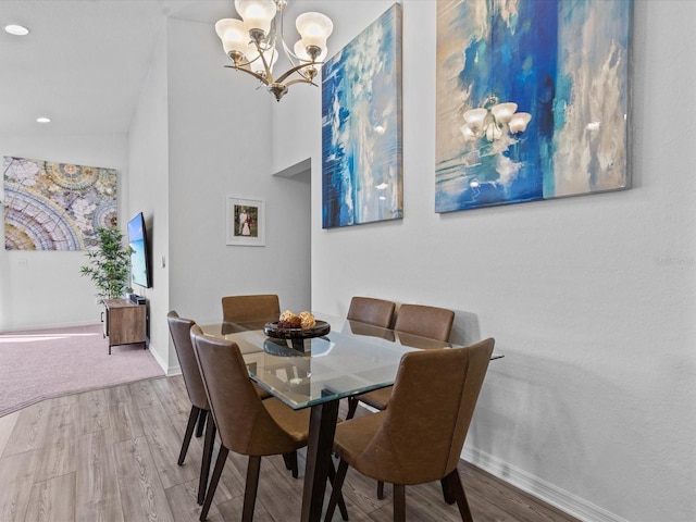 dining room featuring hardwood / wood-style floors and a chandelier