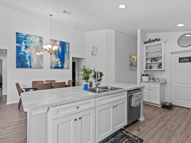 kitchen with dishwasher, decorative light fixtures, white cabinets, and sink