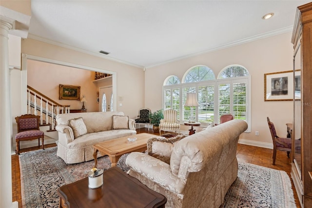 living room with decorative columns and ornamental molding