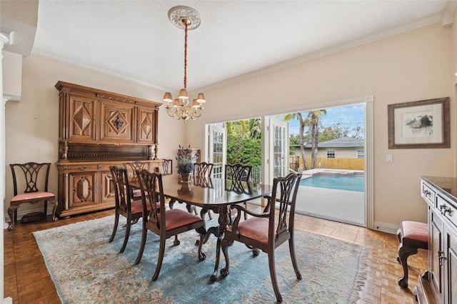 dining room with crown molding, parquet flooring, and a notable chandelier