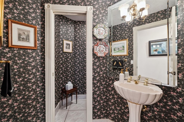 bathroom with tile patterned flooring and a notable chandelier