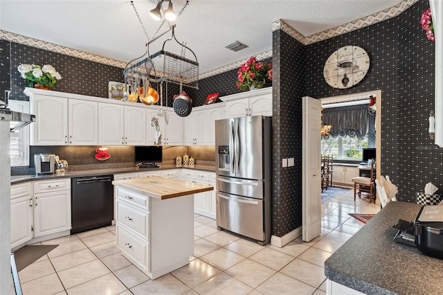 kitchen with wood counters, a center island, white cabinets, black dishwasher, and stainless steel fridge with ice dispenser