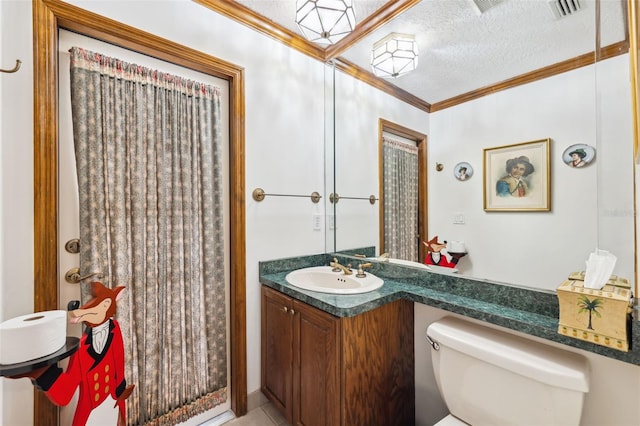 bathroom with vanity, a textured ceiling, toilet, and ornamental molding