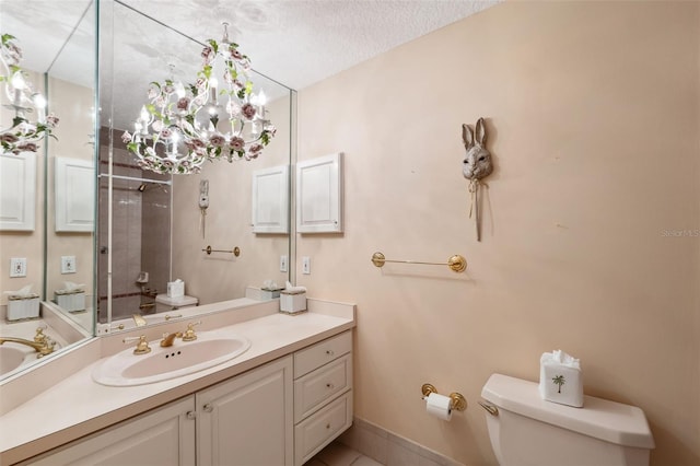 bathroom featuring vanity, a textured ceiling, and toilet