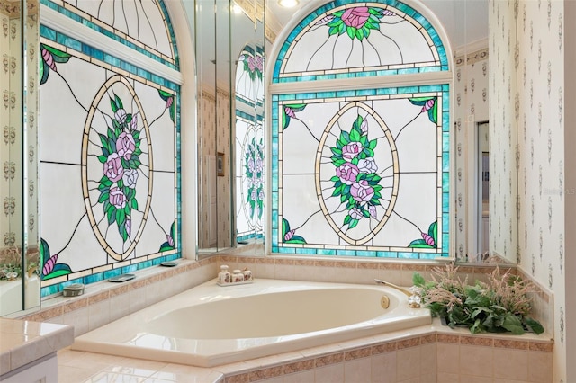 bathroom with vanity and tiled bath