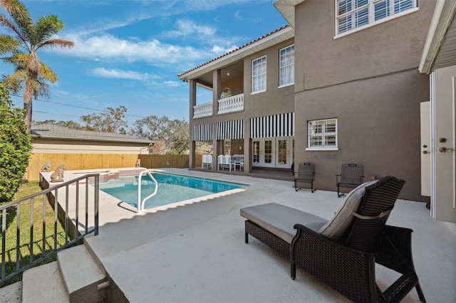 view of pool with a patio area and french doors