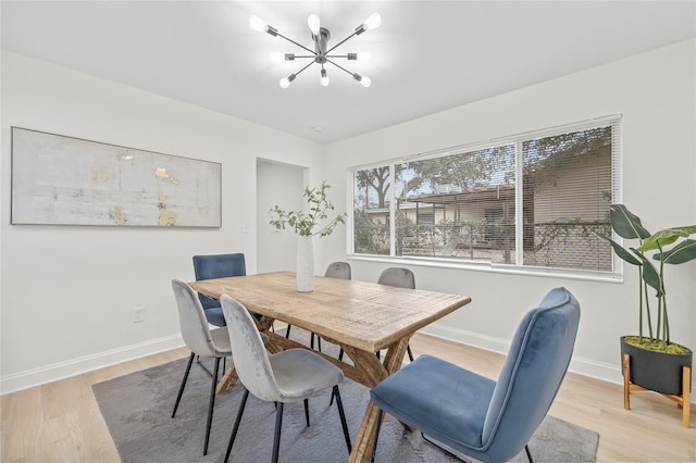 dining room featuring light hardwood / wood-style floors and an inviting chandelier