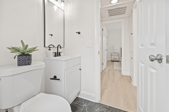 bathroom featuring toilet and vanity