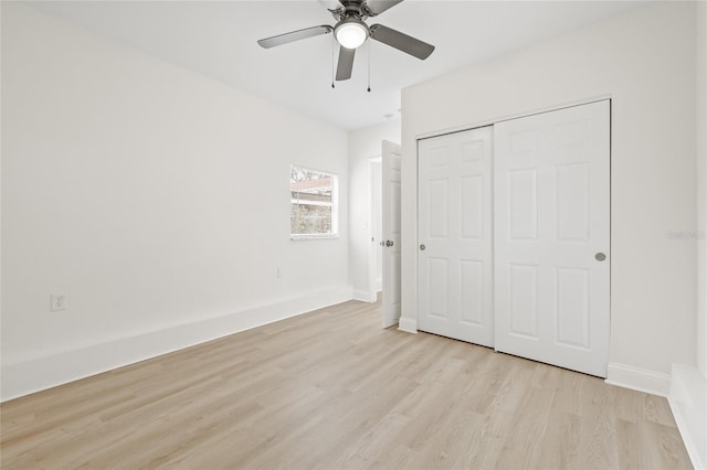 unfurnished bedroom with light wood-type flooring, ceiling fan, and a closet