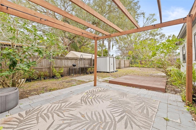 view of patio / terrace with a pergola and a storage shed