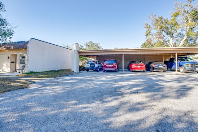 view of vehicle parking with a carport