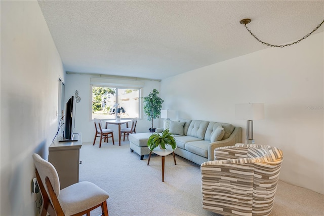 living room featuring light colored carpet and a textured ceiling