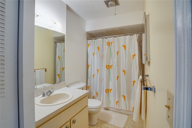 bathroom featuring vanity, toilet, a textured ceiling, and walk in shower